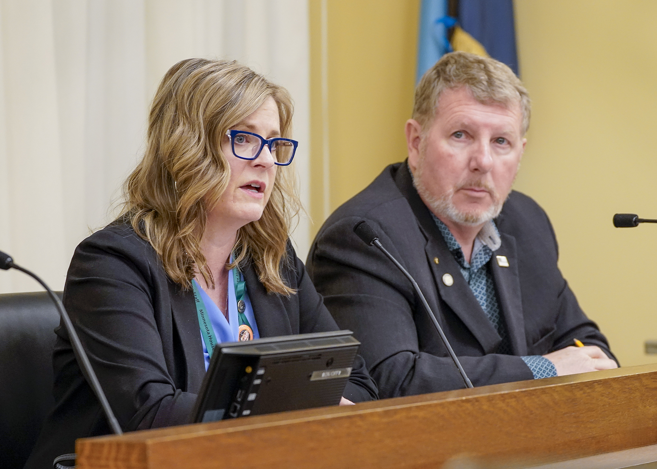 Rep. Kelly Moller and Rep. Paul Novotny speak to HF3230 at the April 27 meeting of the House Ways and Means Committee. The bill would modify and expand requirements related to security and protective services provided by the State Patrol and Capitol Security. (Photo by Andrew VonBank)